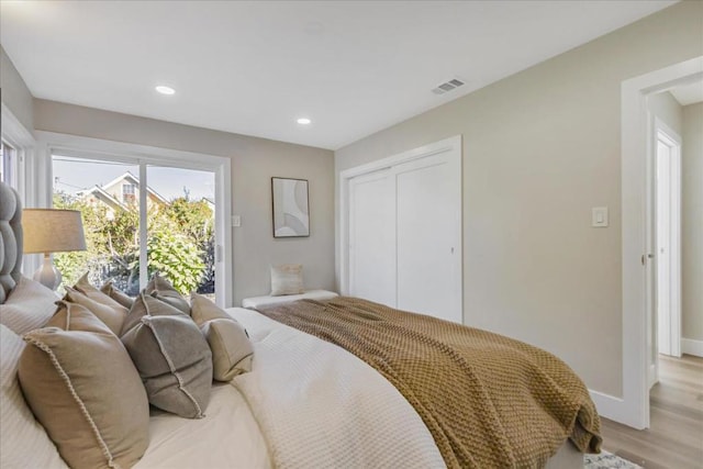 bedroom featuring a closet and light hardwood / wood-style flooring