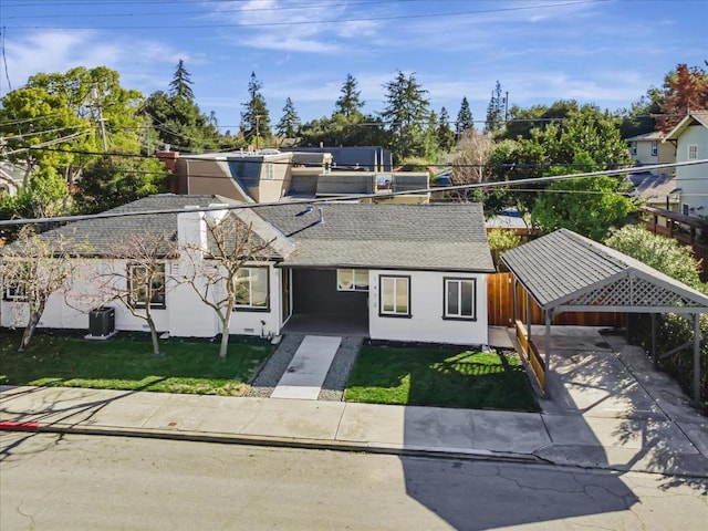 view of front of home featuring a front yard and cooling unit