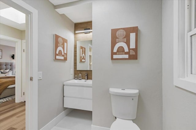 bathroom featuring toilet and vanity