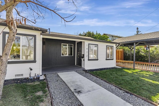 property entrance with a lawn