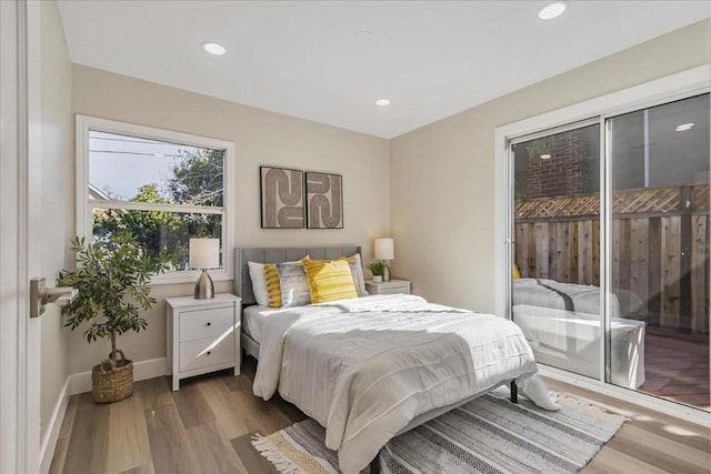 bedroom featuring access to exterior and light hardwood / wood-style flooring