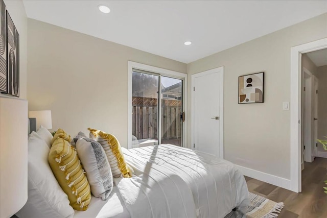 bedroom featuring access to exterior and hardwood / wood-style floors