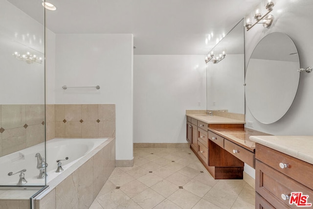 bathroom with vanity, tile patterned flooring, a relaxing tiled tub, and an inviting chandelier