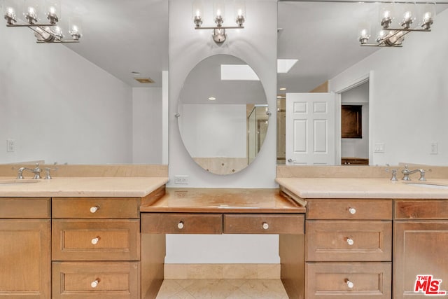 bathroom featuring tile patterned flooring, vanity, and an inviting chandelier