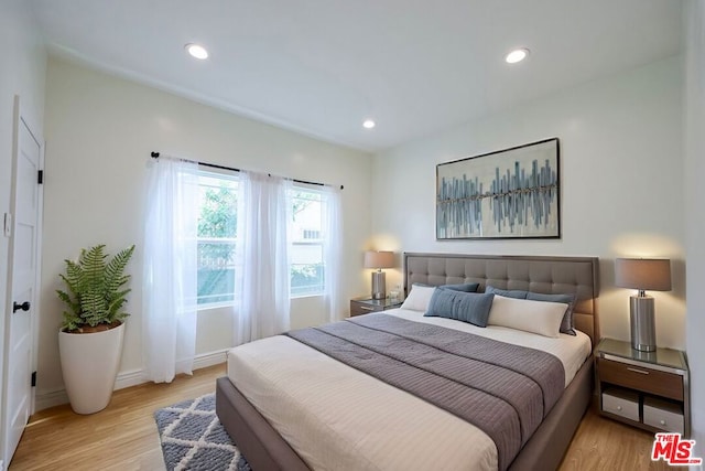 bedroom with light hardwood / wood-style flooring