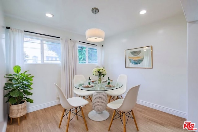 dining space with light hardwood / wood-style flooring