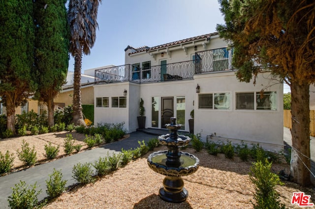 mediterranean / spanish-style house featuring a balcony