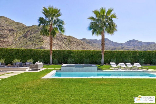 view of pool featuring a lawn, a mountain view, and an in ground hot tub