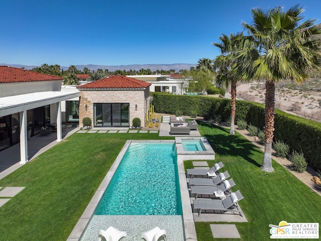 rear view of house with a pool with hot tub, a yard, an outdoor living space, and a patio