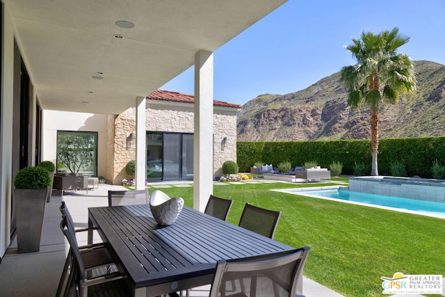 view of patio / terrace with a mountain view, a fenced in pool, and an outdoor hangout area