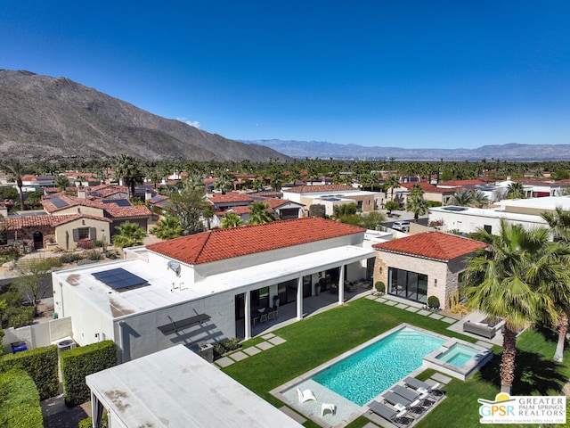 birds eye view of property with a mountain view