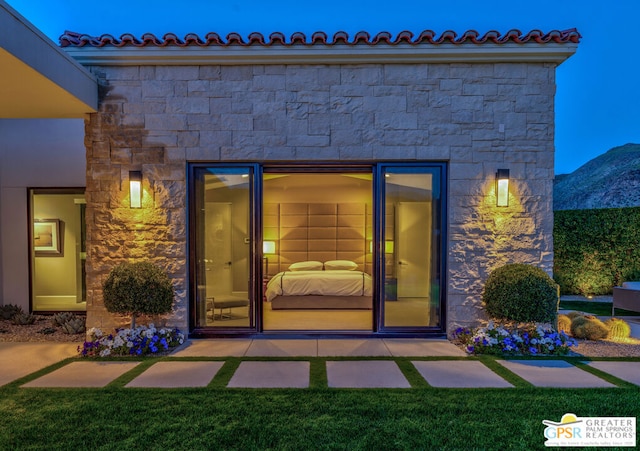 view of exterior entry with a mountain view