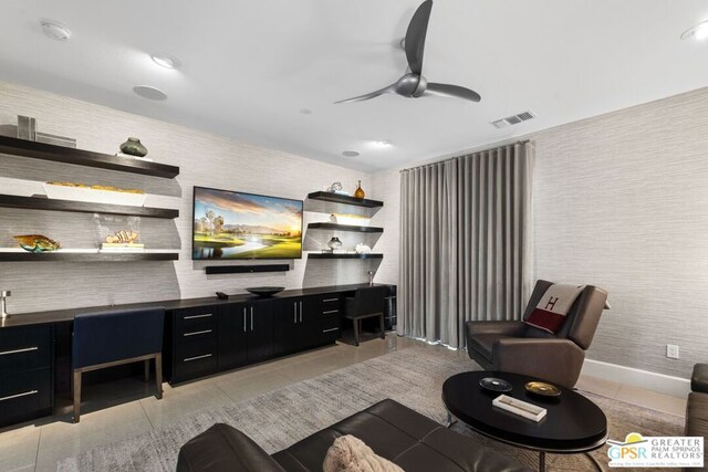 living room with ceiling fan and light tile patterned floors