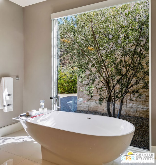 bathroom featuring tile patterned floors and a bathing tub