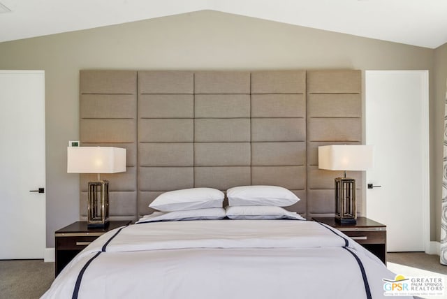 carpeted bedroom featuring lofted ceiling