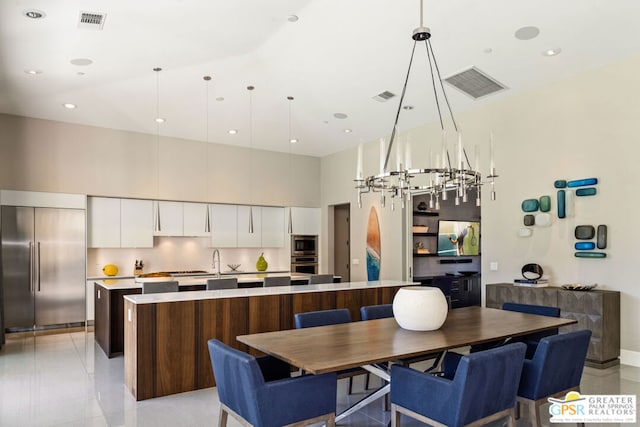 dining area with a high ceiling and sink