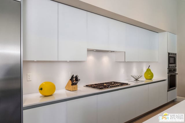 kitchen featuring stainless steel appliances and white cabinets