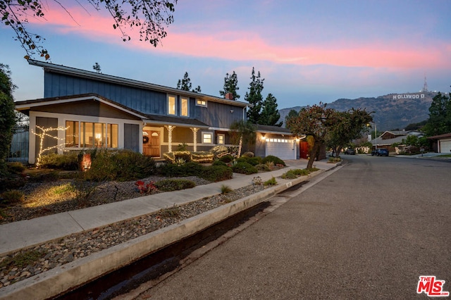 view of front facade featuring a mountain view and a garage