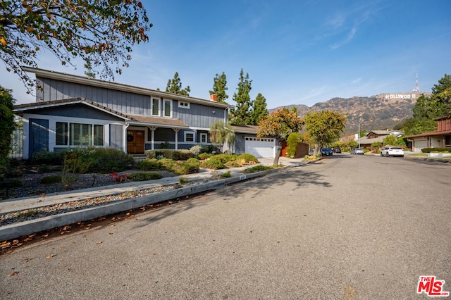 view of front property featuring a garage and a mountain view