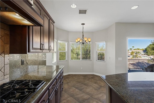 kitchen with decorative backsplash, premium range hood, black gas cooktop, a chandelier, and dark brown cabinets