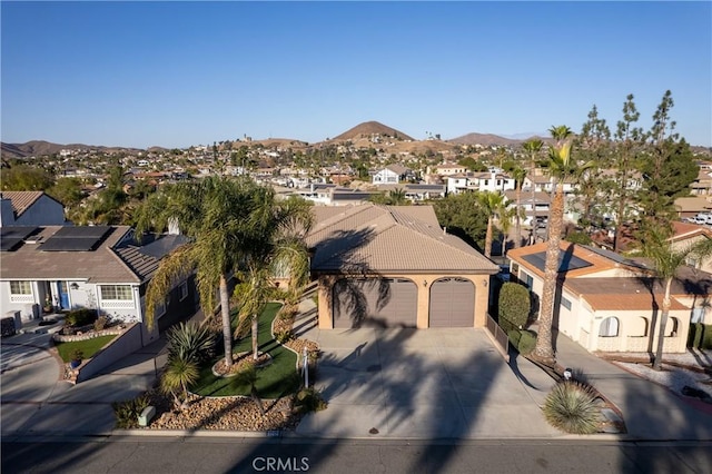 view of front of house with a mountain view and a garage