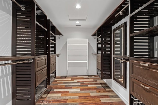 walk in closet with light hardwood / wood-style flooring