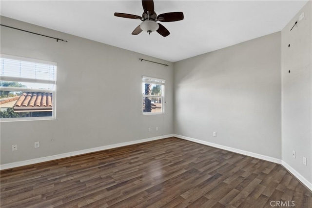 empty room with ceiling fan and dark wood-type flooring