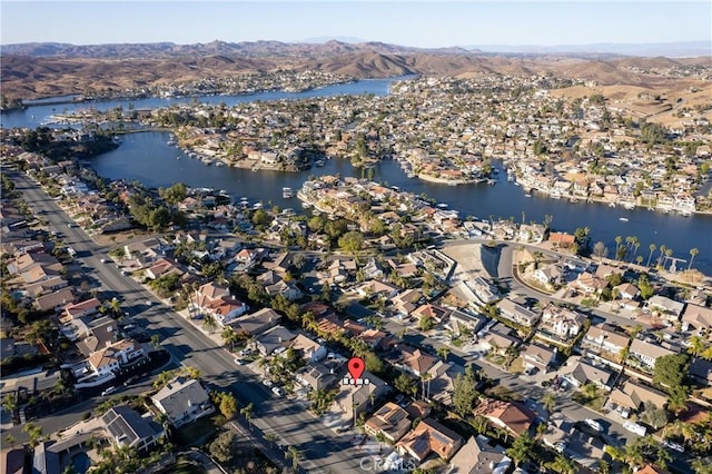 drone / aerial view featuring a water and mountain view