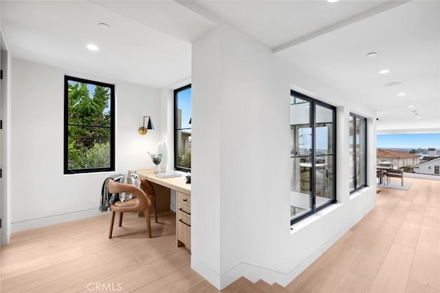 office with baseboards, built in desk, light wood-style flooring, and recessed lighting