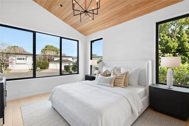 bedroom with vaulted ceiling, light wood finished floors, wooden ceiling, and a notable chandelier