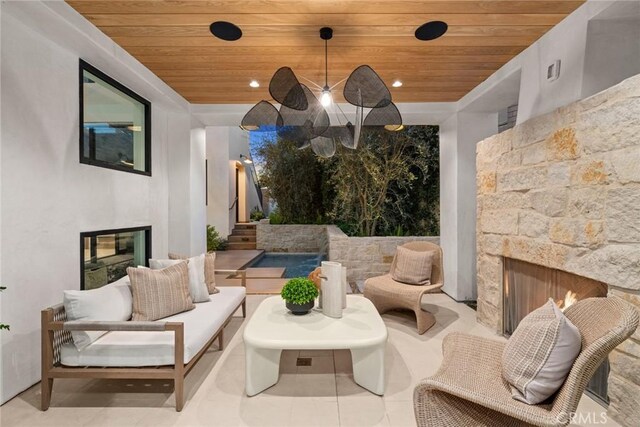 view of patio / terrace with an outdoor living space with a fireplace