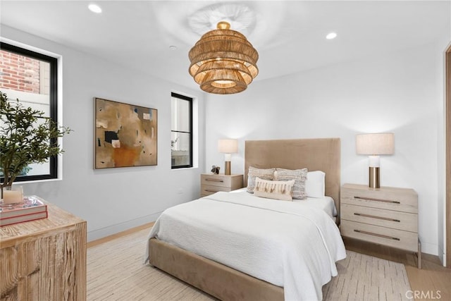 bedroom with light wood-style floors, recessed lighting, and baseboards