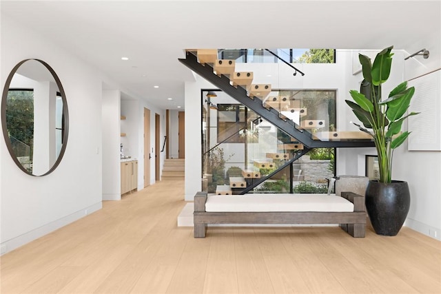 interior space featuring a healthy amount of sunlight, baseboards, wood finished floors, and recessed lighting