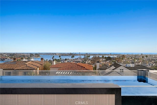 view of swimming pool featuring a water view