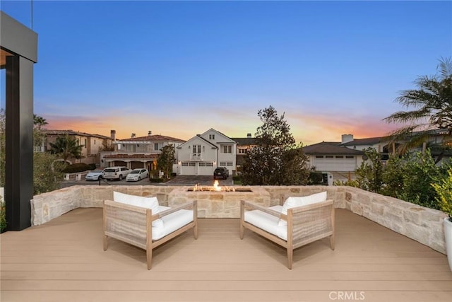 deck at dusk with outdoor lounge area