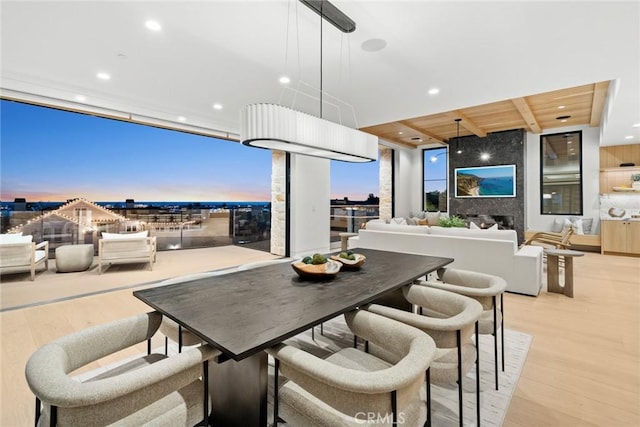 dining room featuring a wall of windows, recessed lighting, wood ceiling, and light wood-style floors