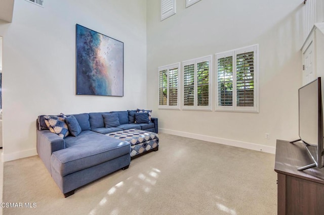 living room featuring a towering ceiling