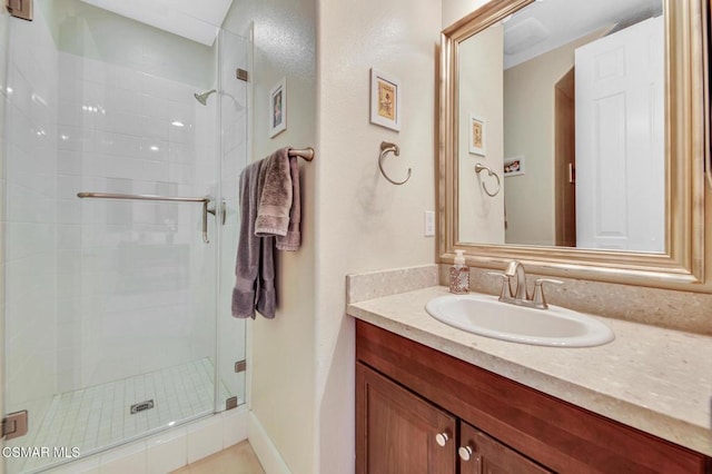 bathroom with tile patterned flooring, walk in shower, and vanity