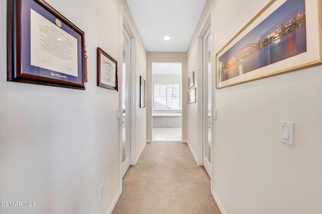 hallway featuring light carpet