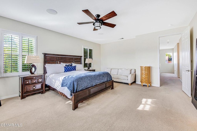 bedroom with ceiling fan and light colored carpet