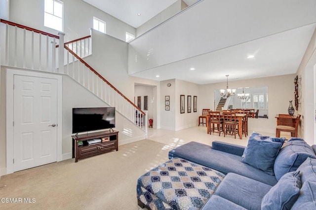 carpeted living room with a chandelier and a towering ceiling