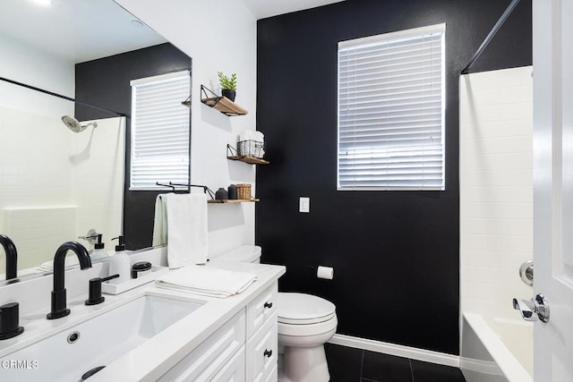 full bathroom featuring toilet, vanity, tile patterned flooring, and washtub / shower combination