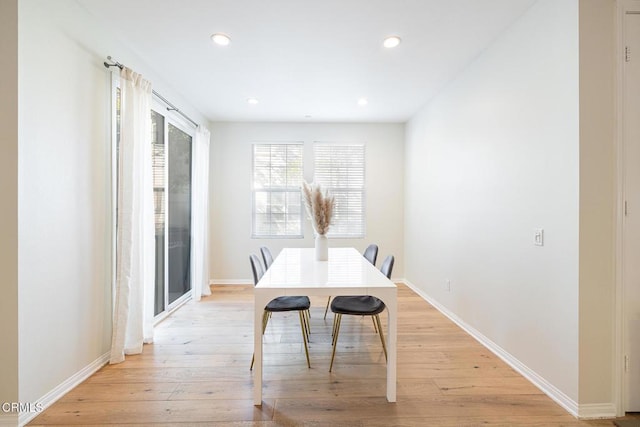 dining space with light hardwood / wood-style floors