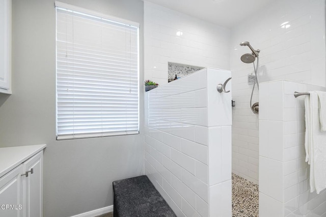 bathroom featuring vanity and a tile shower