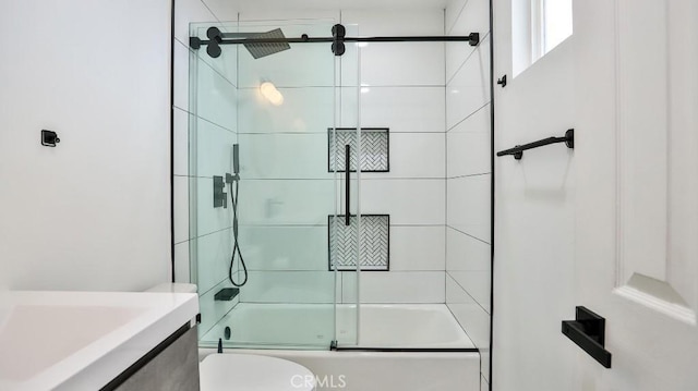 full bathroom featuring toilet, combined bath / shower with glass door, and vanity