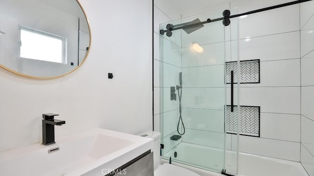 full bathroom featuring toilet, vanity, and shower / bath combination with glass door