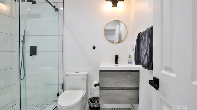 bathroom with toilet, a shower with shower door, and vanity