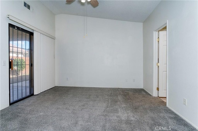 spare room featuring ceiling fan, carpet, and lofted ceiling