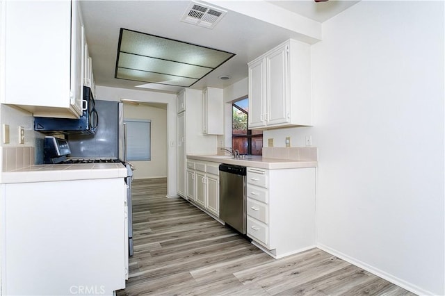 kitchen with range with gas cooktop, light hardwood / wood-style floors, dishwasher, white cabinets, and sink