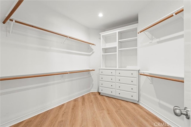 walk in closet featuring light hardwood / wood-style flooring